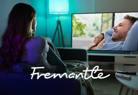 woman watching TV with Fremantle logo overlay