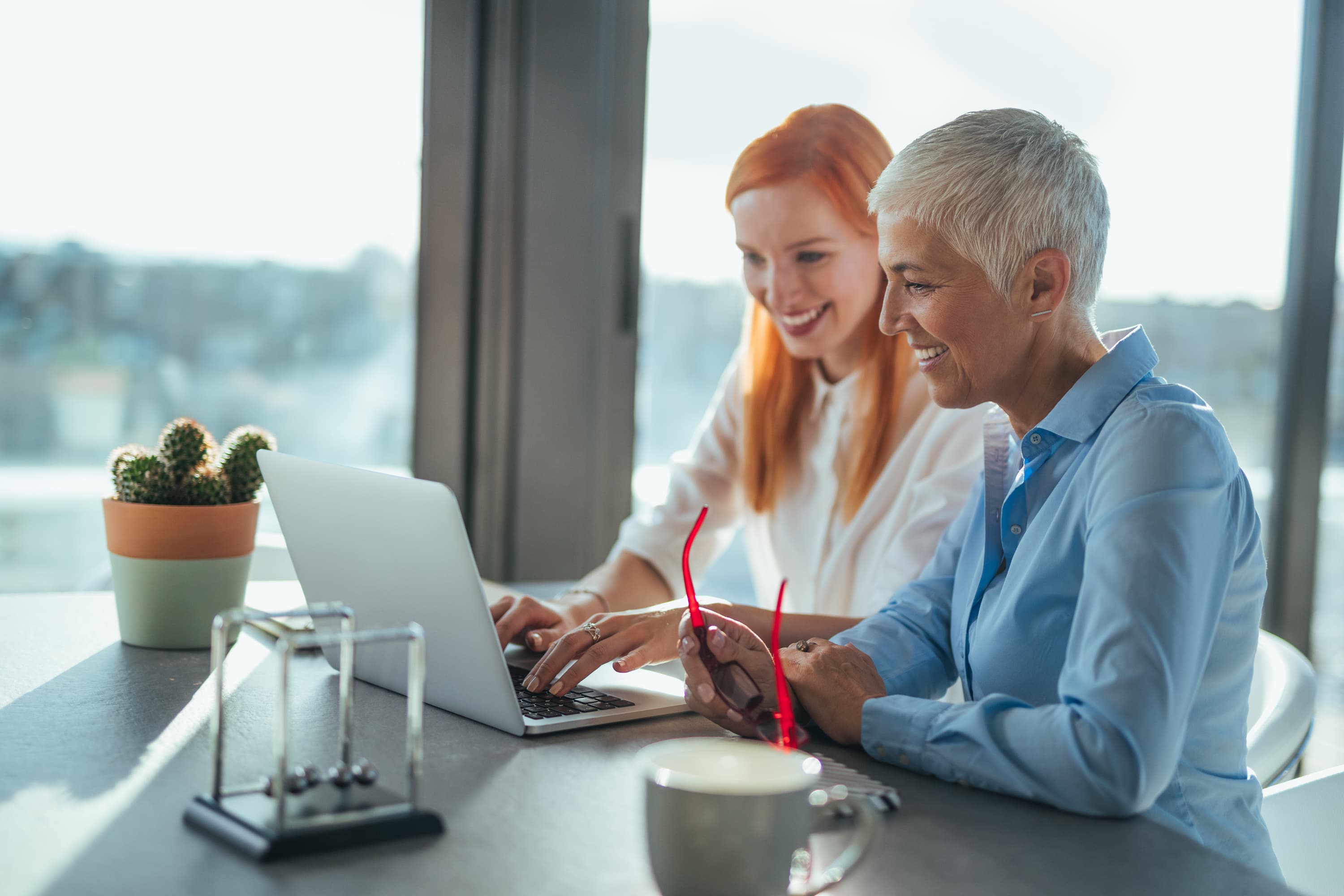 Two people typing at keyboard