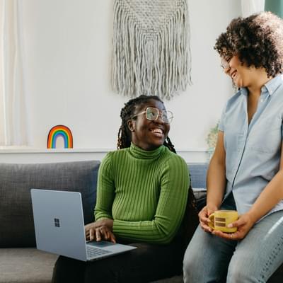 Two women working on a laptop