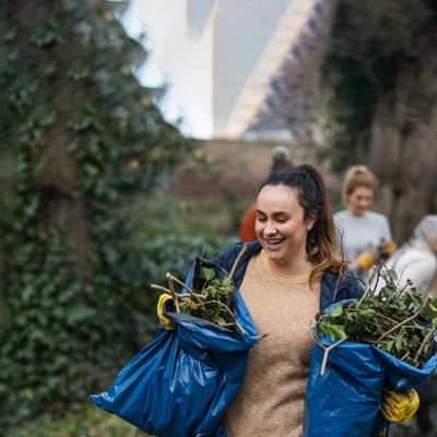 Volunteers with bags of leaves