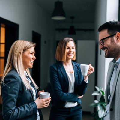 Workers chatting in hallway