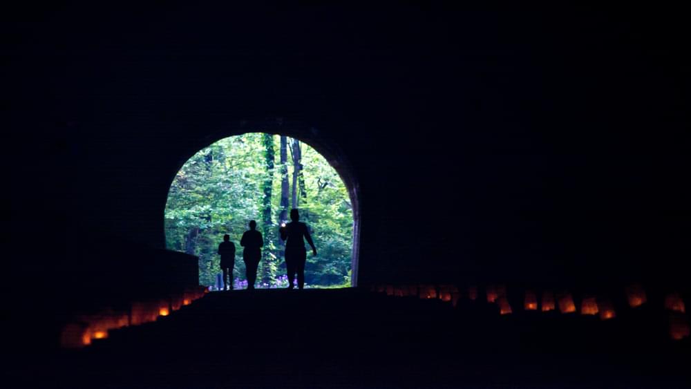 The Path of the Flood Trail follows the route of the devastating Johnstown Flood in 1889. Here, luminarias light the Staplebend Tunnel prior to a foot race that has taken place over the past 5 years, and attracted nearly 1,000 participants in 2018. 