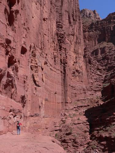 Red rocks wall with hiker for scale; photo by Stuart Macdonald