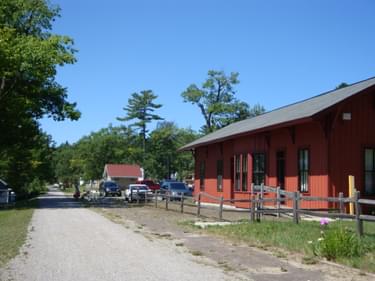 Topinabee features the old railroad station, a picnic area, and beach on Mullet Lake