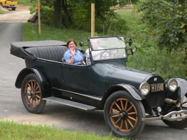 Susan Moerschel, Planning Chief, Division of Parks &amp; Recreation, riding in a 1918 Buick