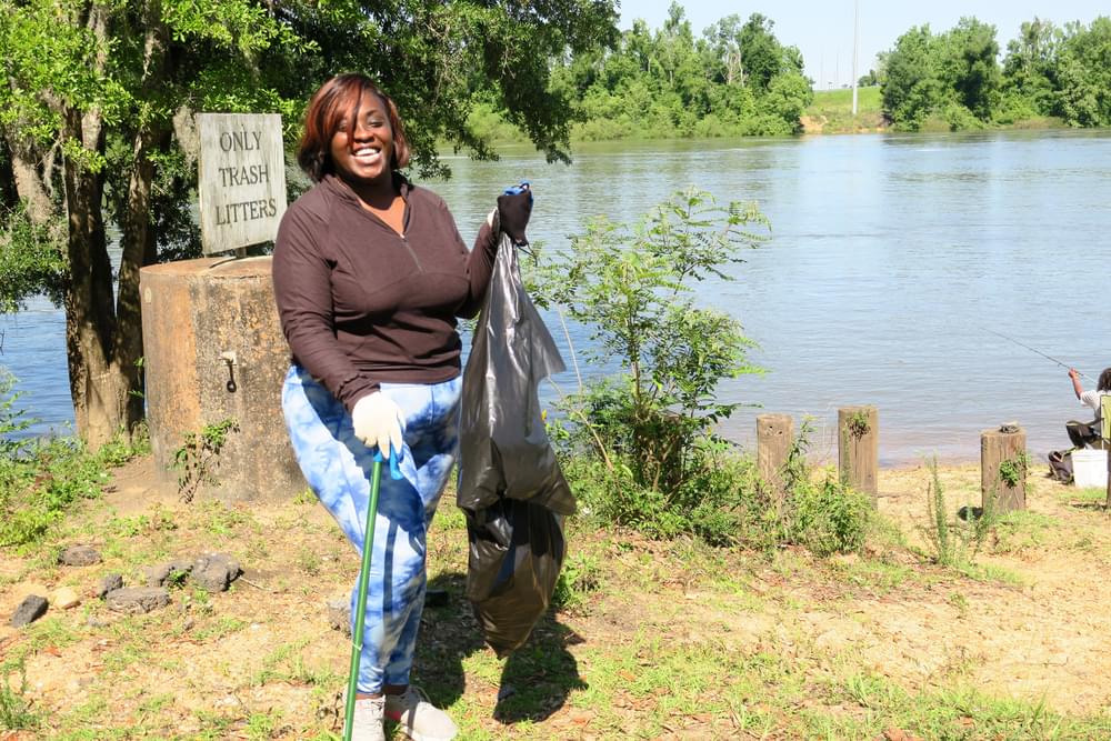 Angie Riviere, volunteer coordinator of Outdoor Afro Tallahassee, cleans up along the Apalachicola Blueway.