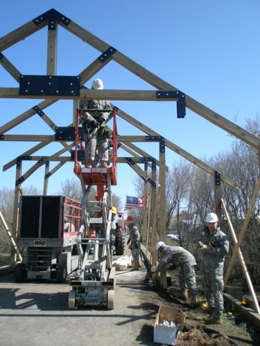 Example of military partnerships: Volunteer Army Reserves constructing covered bridge on Lake Wobegon Trail, Holdingford, MN; photo by Chuck Wocken