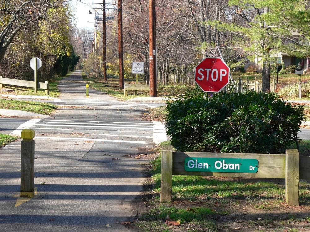 On Baltimore and Annapolis Rail Trail, street sign helps orient trail users; note rare use of bollard