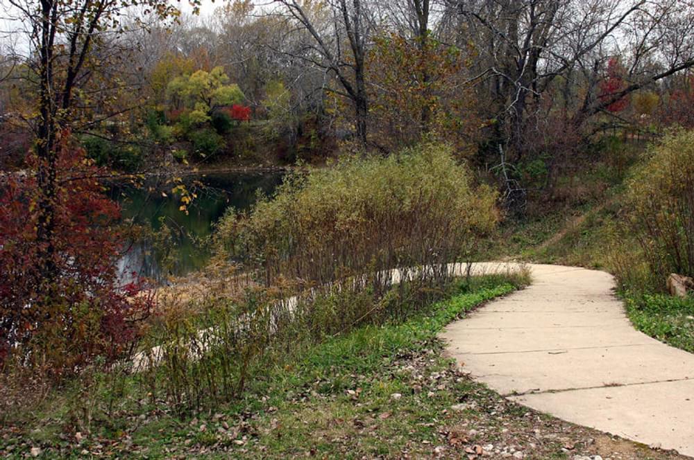 Concrete walk leads down to pond for accessible fishing.