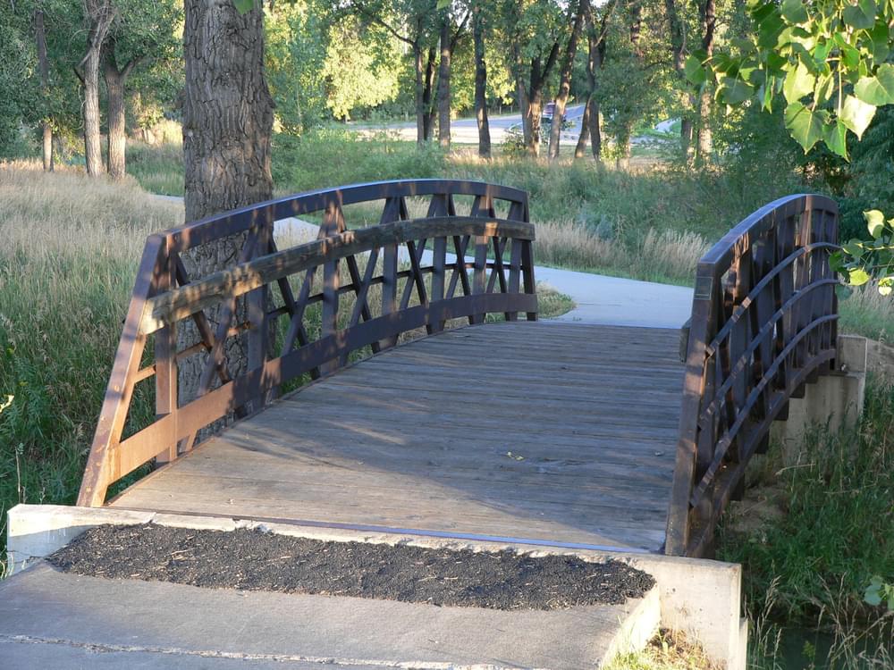 Example of an asphalt patch at the concrete sill which the bridge abuts against; Little Dry Creek Trail, Arvada, Colorado