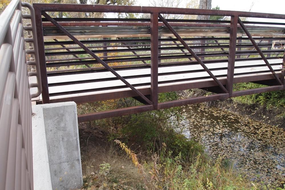 Detail of steel bridge with concrete abutment on the Highline Canal Trail in Greenwood Village, Colorado