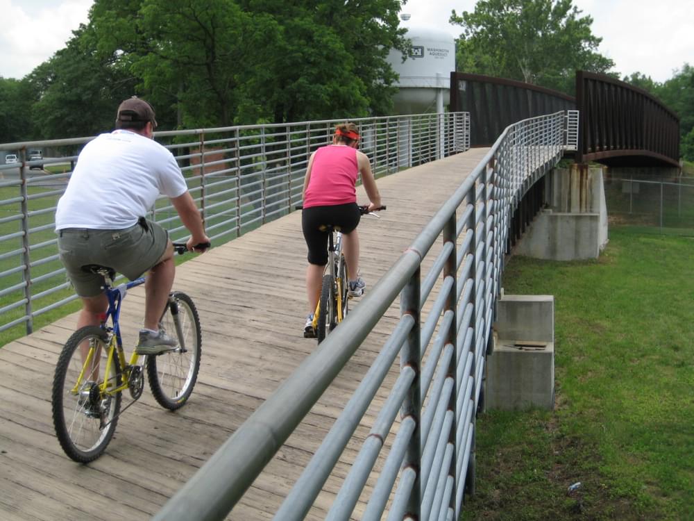 Boardwalk rises to long steel bridge on the Capital Crescent Trail in Montgomery County, Maryland