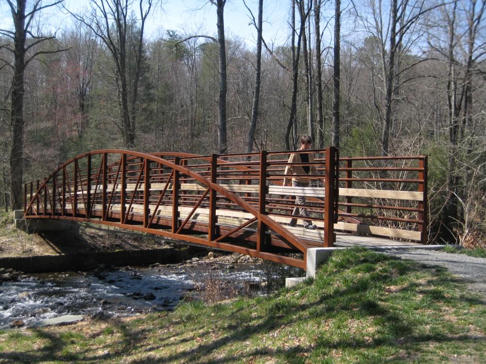 Steel trail bridge over river in Pisgah National Forest near Asheville, North Carolina