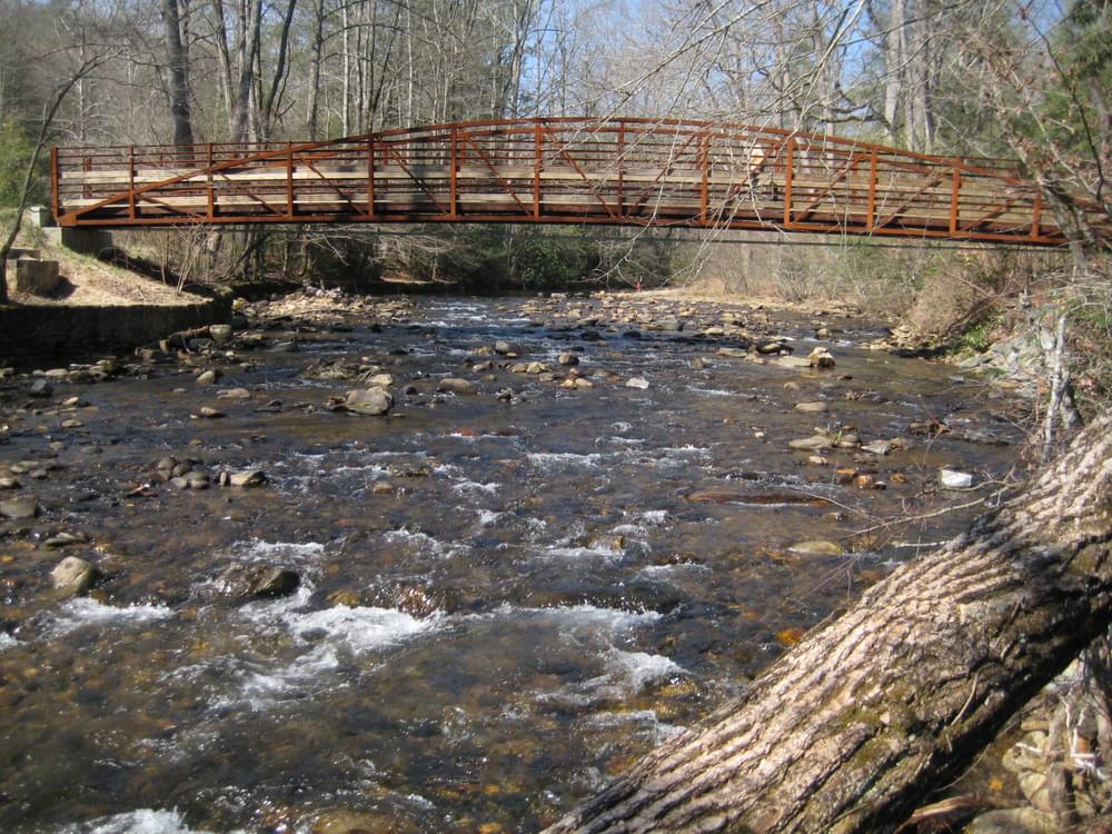 Steel trail bridge over river in Pisgah National Forest near Asheville, North Carolina