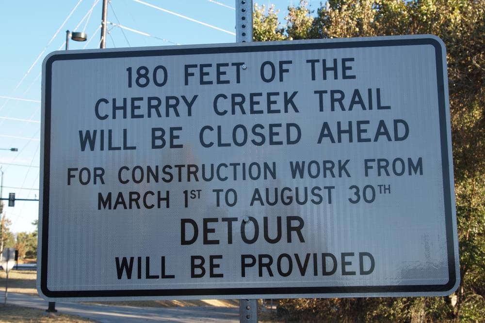 Sign posts details of future trail closure, including specific dates, Cherry Creek Trail in Denver, Colorado