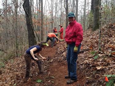 Volunteers using hand tools to construct new trails