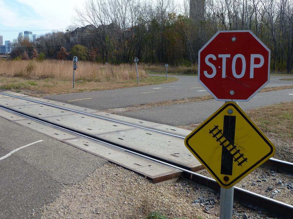Sign warns trail users that railroad crosses trail at an angle; Minneapolis Cedar Lake Regional Trail 