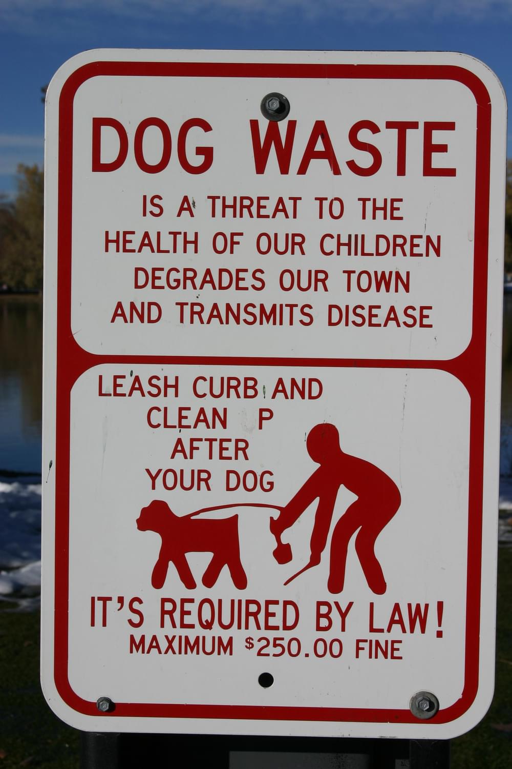 Stern warning about dog waste hazards in Bluff Lake Park, a habitat area on Sand Creek in Denver, Colorado