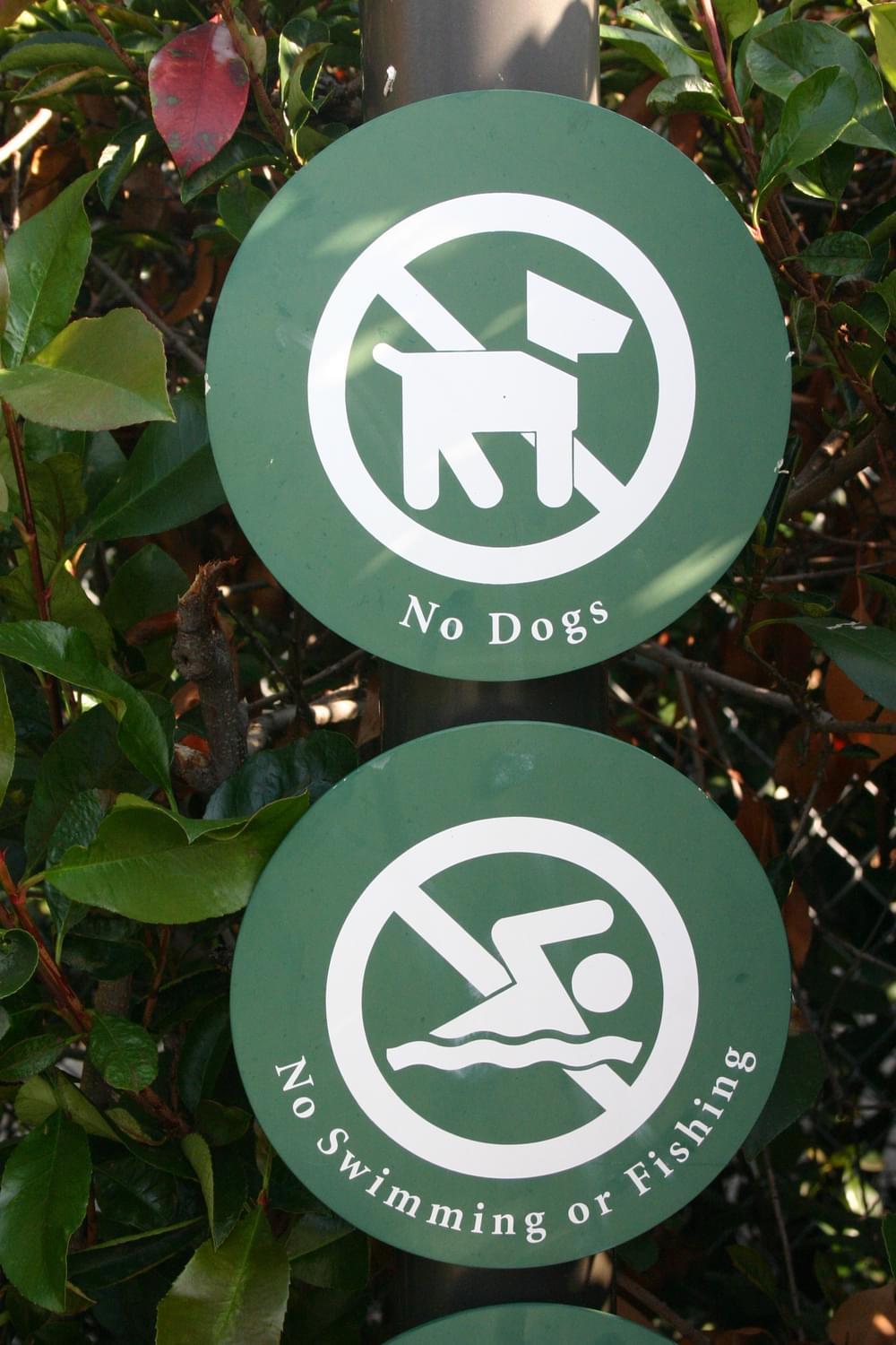 Park in Redding, CA shows prohibited activities as small symbols on a signpost