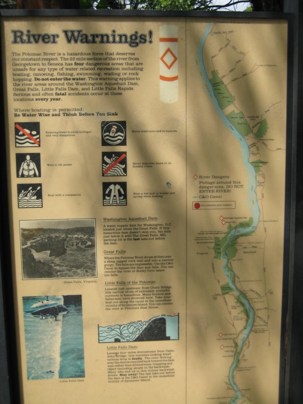 Warning signs showing specific river hazard areas on the C and O Canal Trail adjacent to the Potomac River near Washington, DC