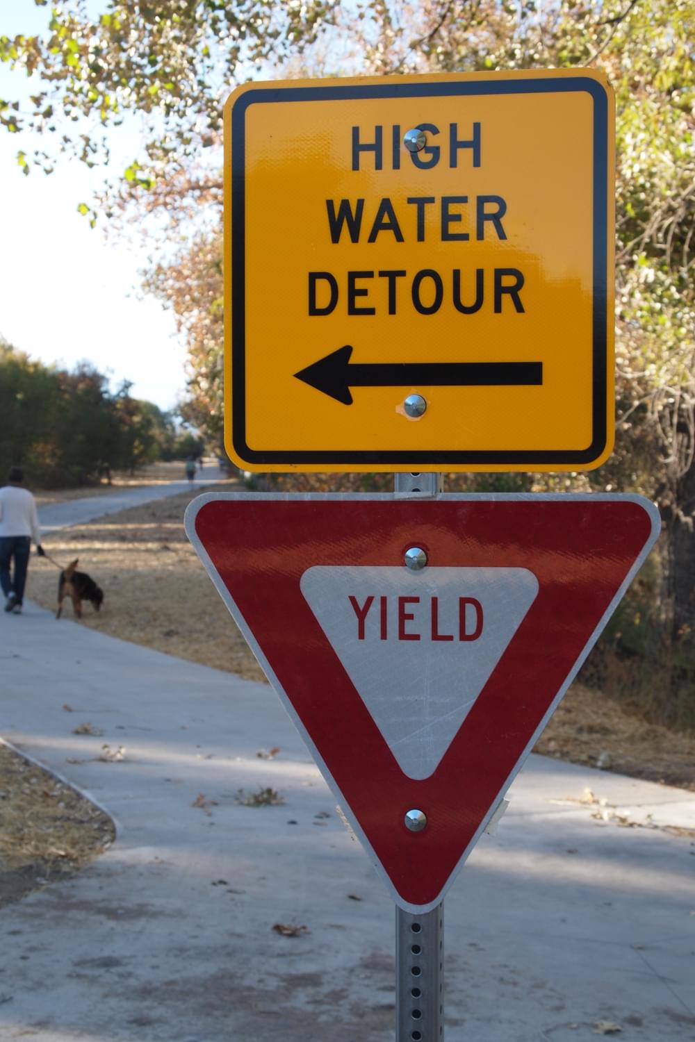 Yield signpost is used for trail detour direction in case of flood; Cherry Creek Trail in Denver 