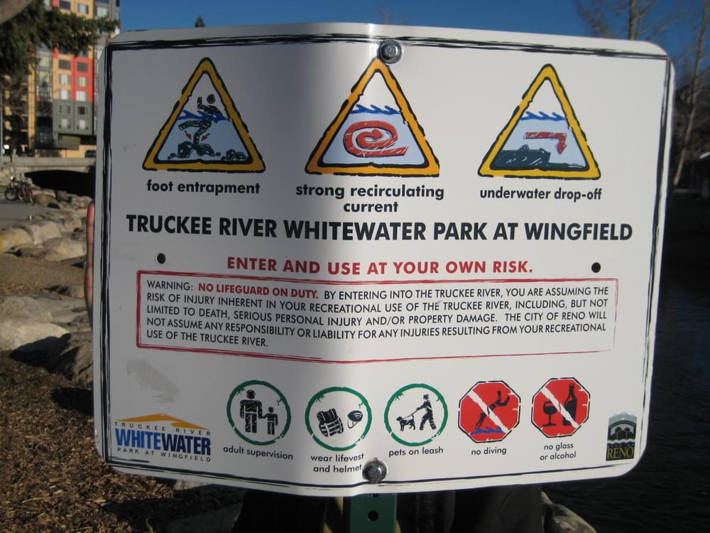Another place to caution users is where the trail is part of a river recreation area; sign along the Truckee River Trail warning of various hazards of entering the water