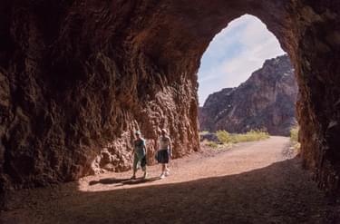 Hikers entering a tunnel; Photo by Andrew Cattoir for NPS, Lake Mead National Recreation Area