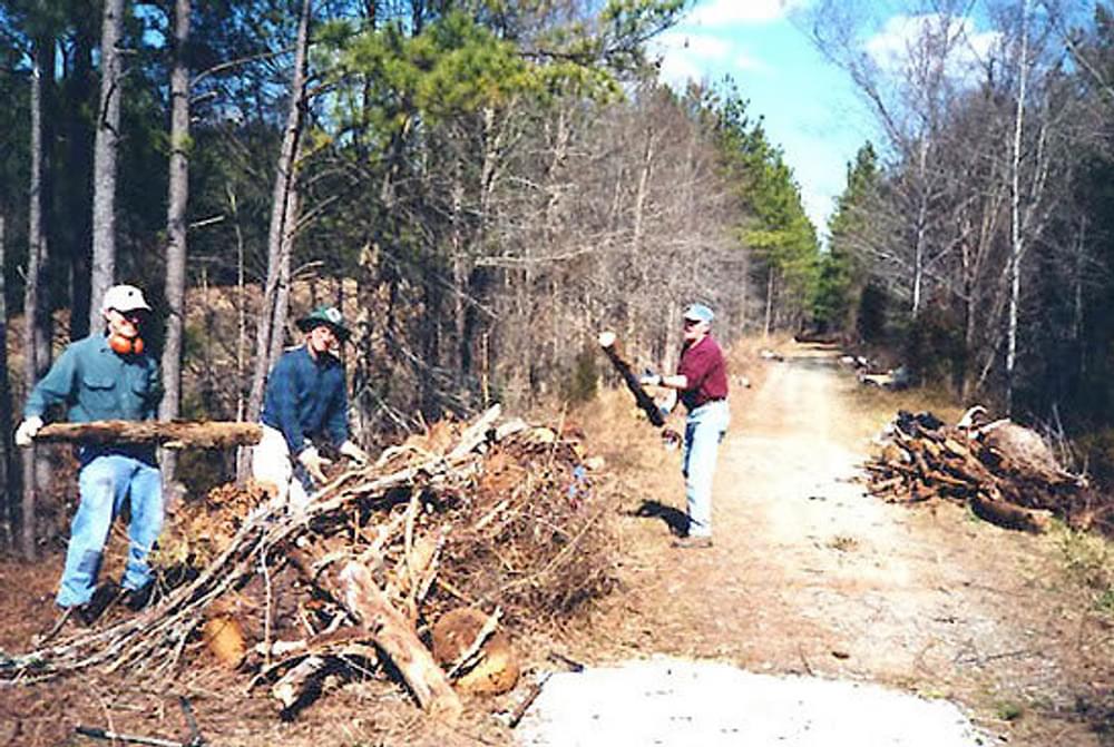 Volunteers clearing deadfall trees on the American Tobacco Trail in North Carolina