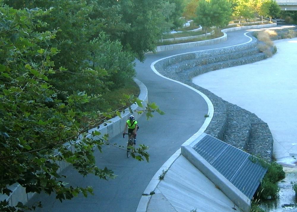 A bike commuter on the Guadalupe River Trail near downtown on the San Jose Trail System