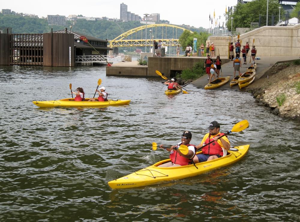 Kayakers finishing a pre-launch briefing and about to launch on the Allegheny River portion of the Three Rivers Water Trail; Pittsburgh, Pennsylvania