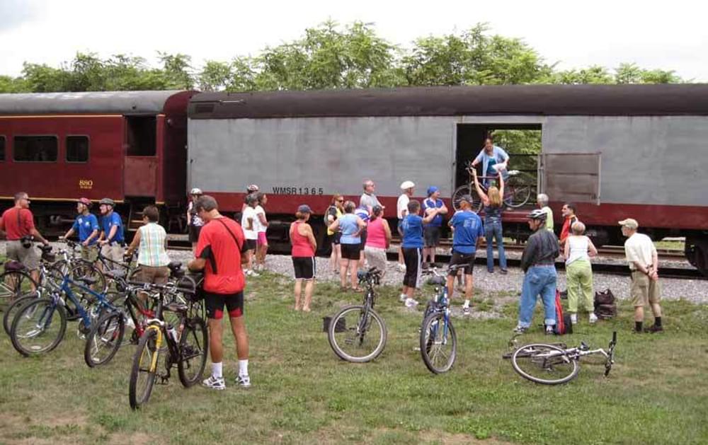 Riders take their bikes on the Western Maryland Scenic Railroad and ride back to Cumberland, Maryland on the Great Allegheny Passage National Recreation Trail