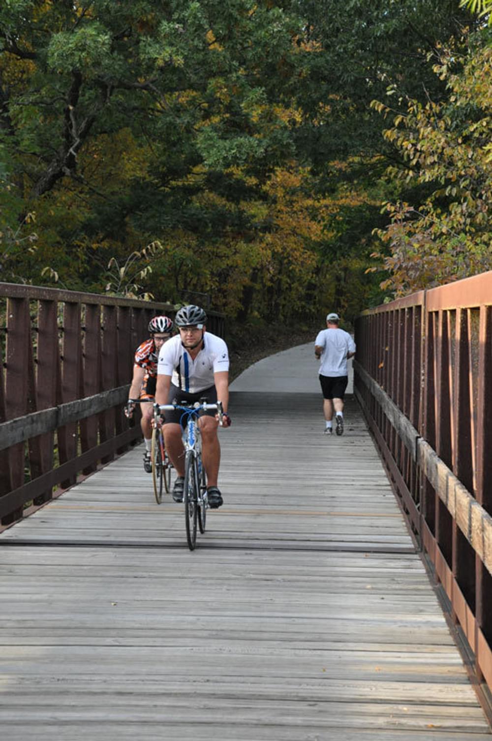 Bicyclists and joggers crossing a bridge on the Neal Smith Trail, Iowa