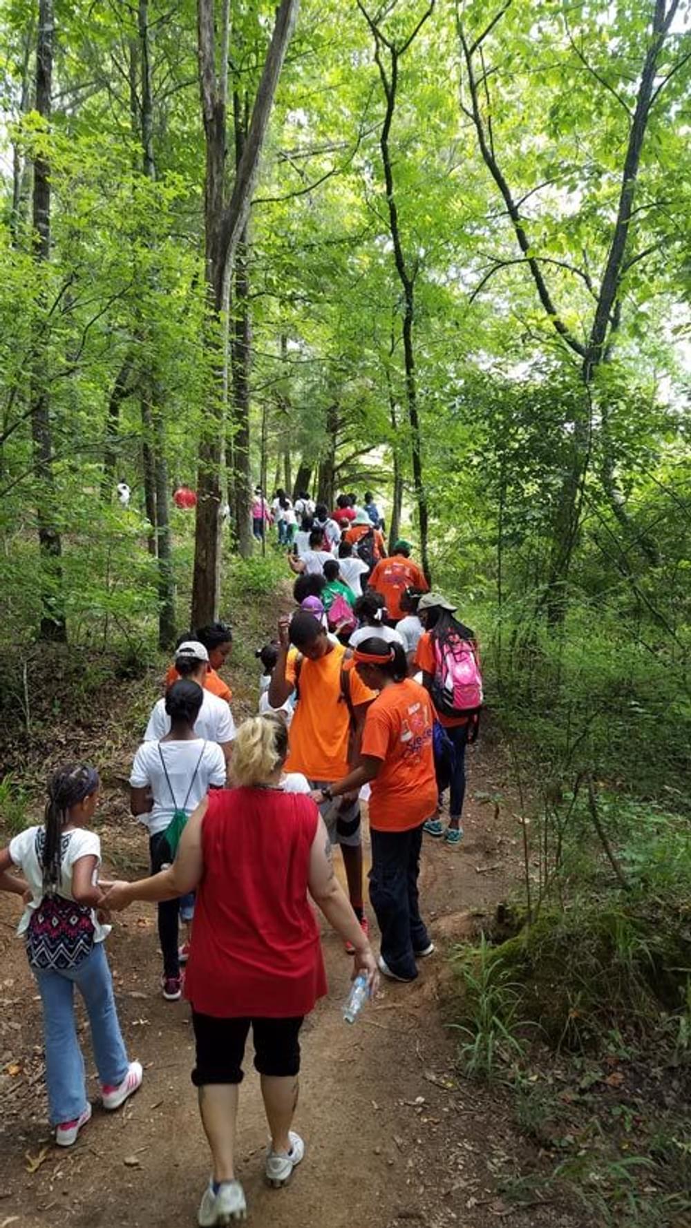 A school class on a guided hike to the waterfall at Chewacla State Park in Alabama