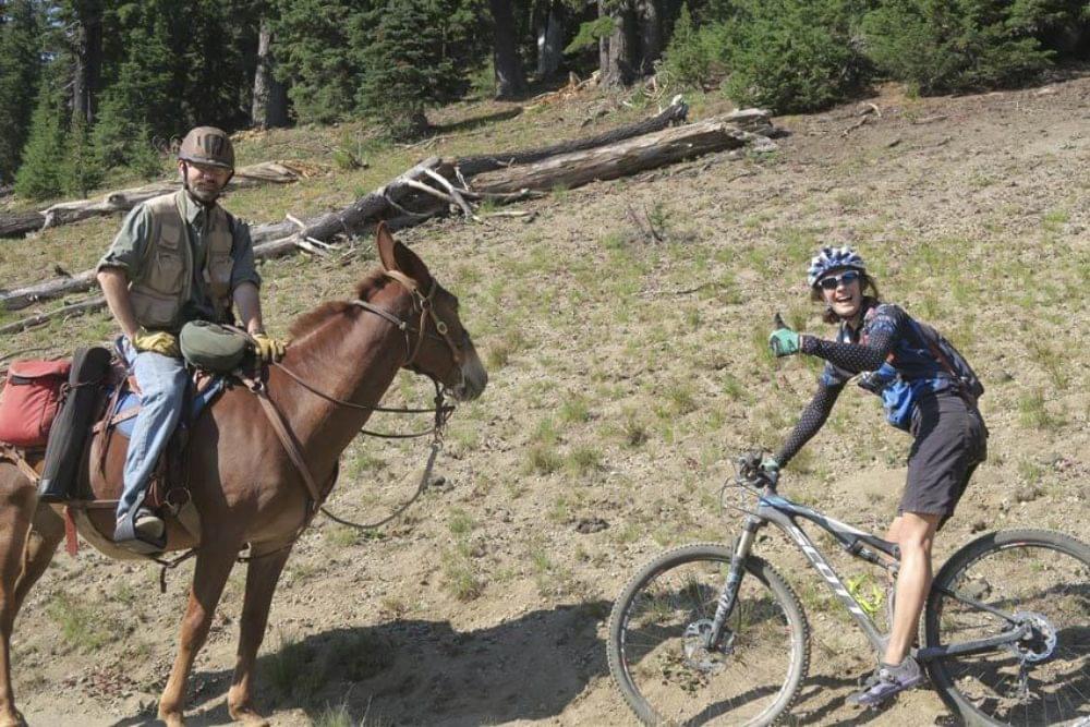 An equestrian and a hiker do a "meet and greet" on the multiuse backcountry trail