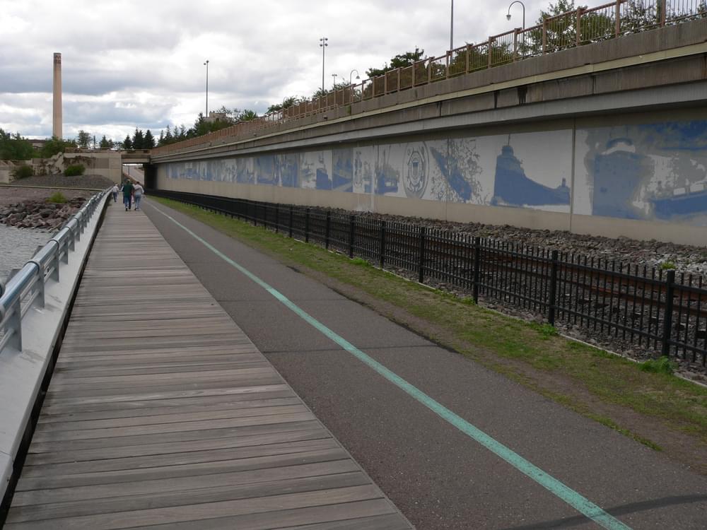 Murals of local history line the Downtown Lakewalk in Duluth, Minnesota, a rails with trail project.