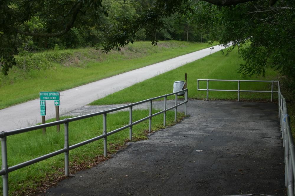 Ramp leads visitors from parking lot down the slope to rail trail on Withlacoochie State Trail, Florida