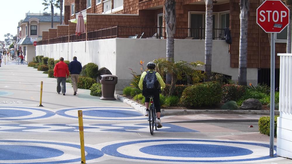 Bold patterns in concrete emphasize road crossing of boardwalk trail, Newport Beach, California