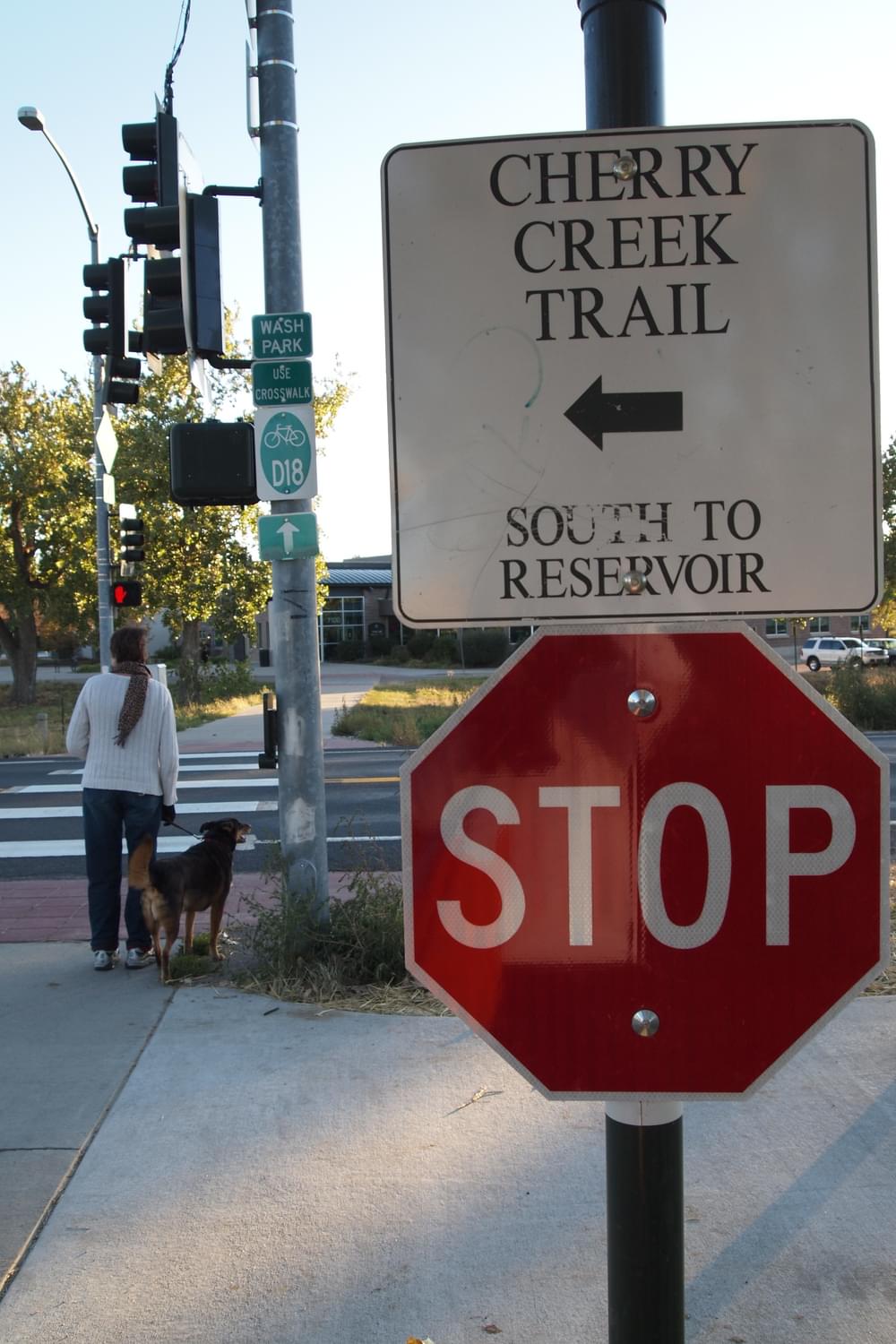 Intersection sign directs users to continuation of the Cherry Creek Trail in Denver, Colorado