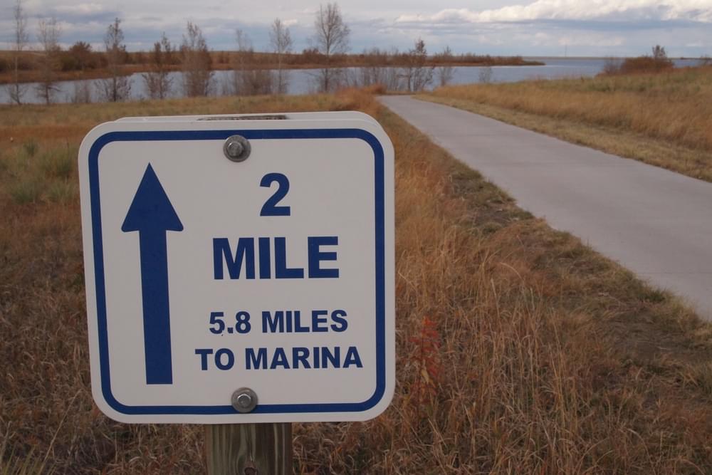 Metal sign marks distance on the Aurora Reservoir Trail; Aurora, Colorado