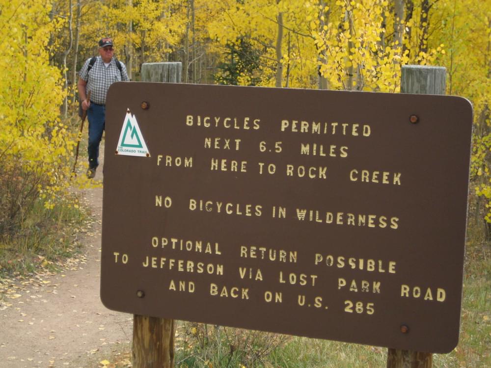 Sign noting how far bikes are allowed on the Colorado Trail at Kenosha Pass on the Pike National Forest