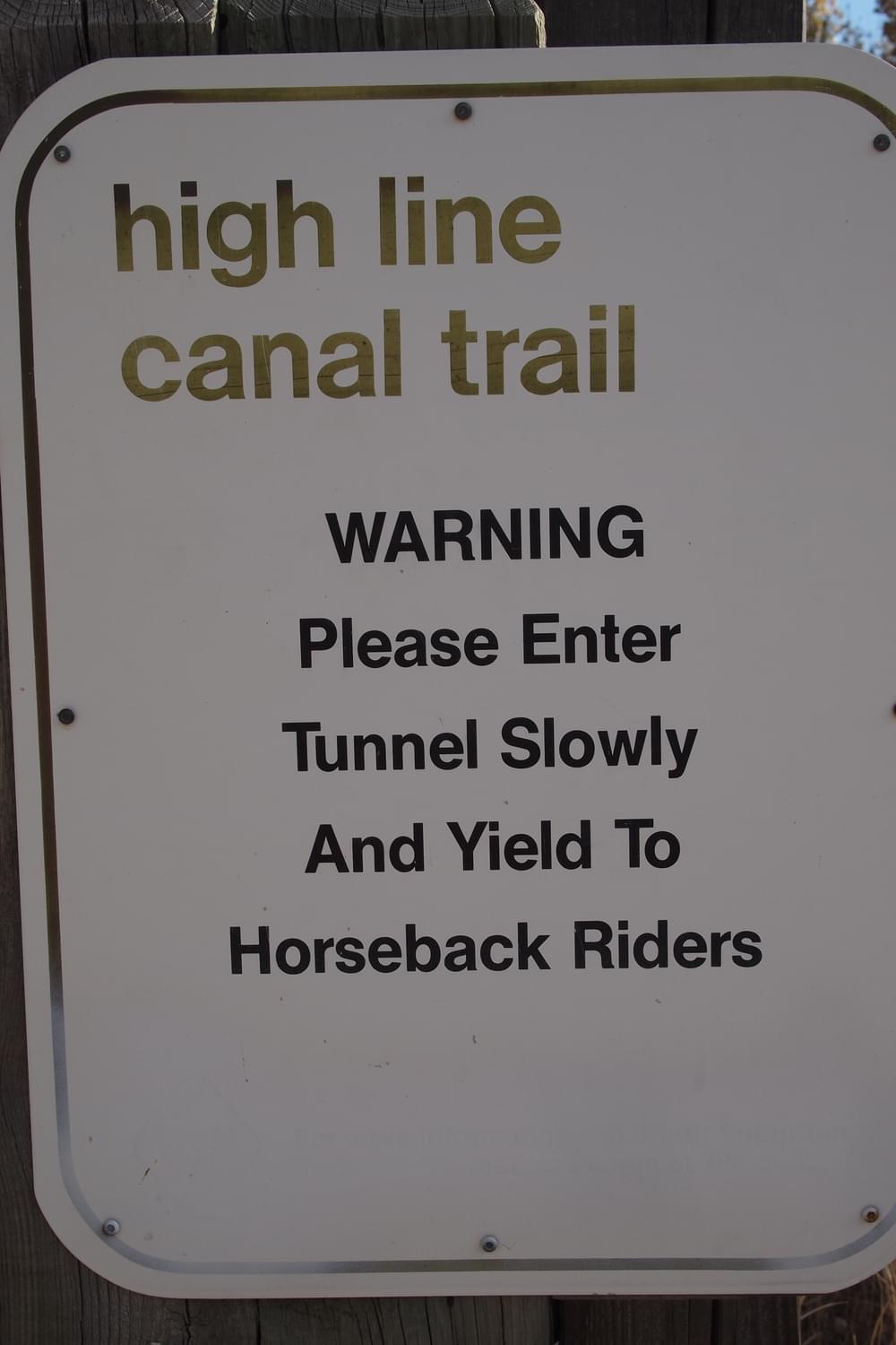 Horseback riders share a tunnel under a roadway with bikers and walkers; Highline Canal Trail, Greenwood Village, Colorado