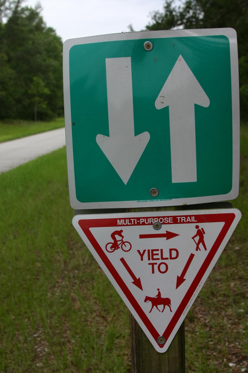 In addition to the yield sign, arrows apparently indicate users are to keep right on the Withlacoochie State Trail, Florida