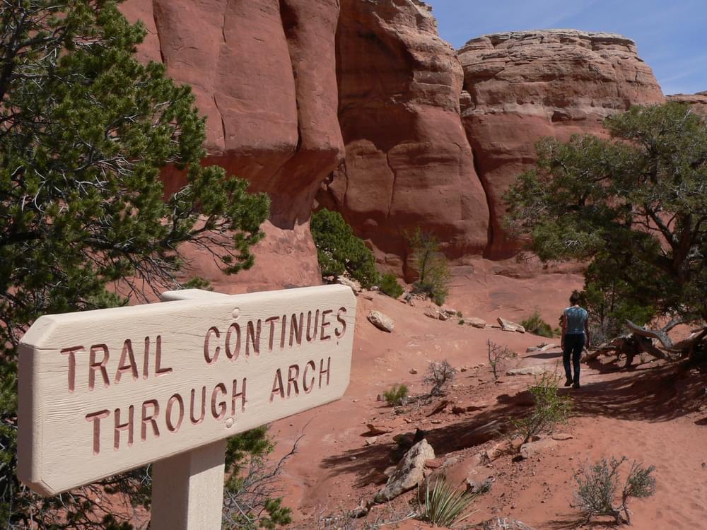 Sign helps users find trail beyond point of interest; Arches National Monument, Moab, Utah
