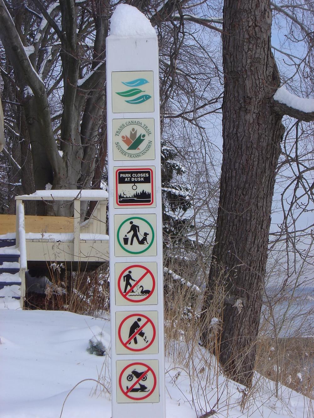 Sign showing trail logo and general park regulations on the Trans Canada Trail