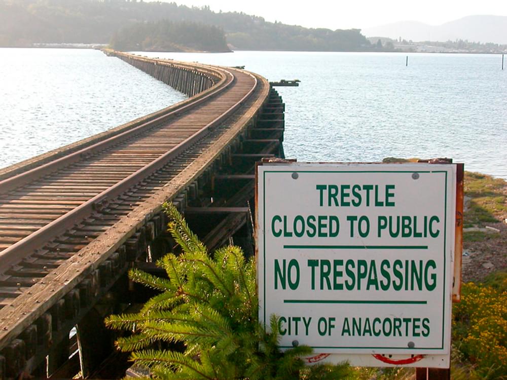 Sign indicating closure of abandoned railroad bridge, now converted to trail use in Anacortes, Washington
