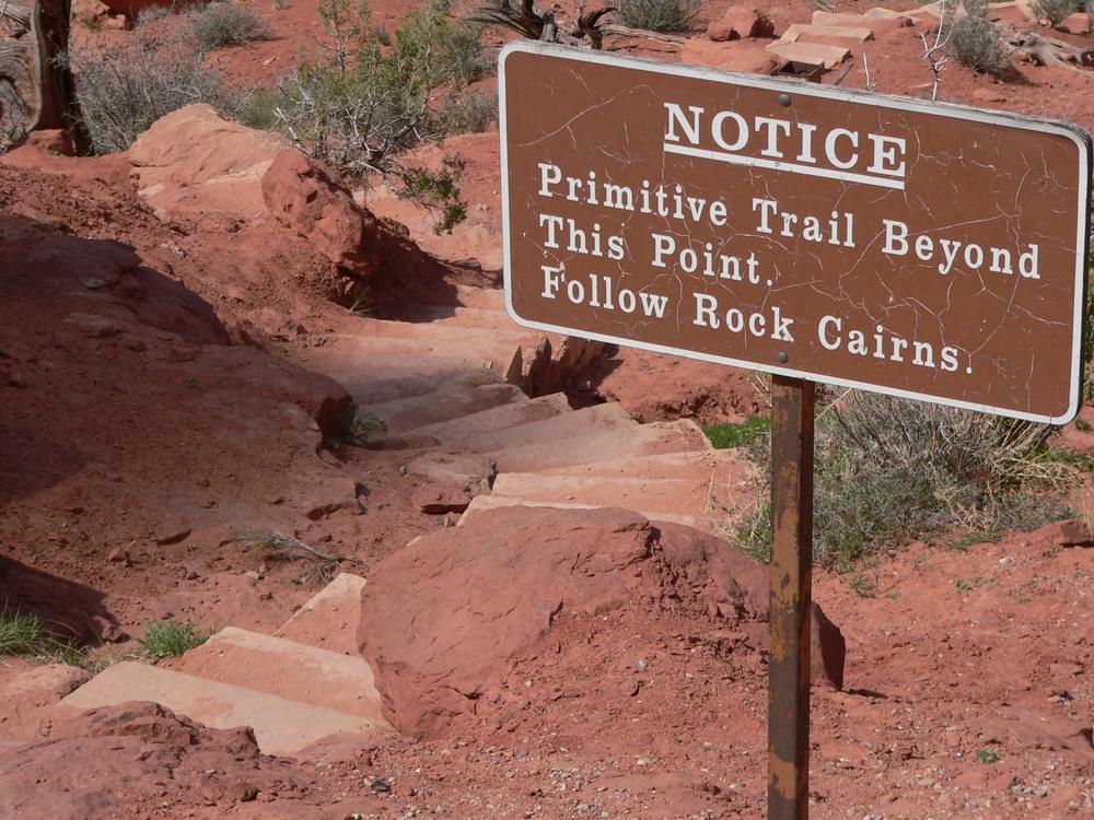 Sign informs visitors that the paved trail to the overlook turns into a narrow, natural surface trail; Arches National Monument, Utah