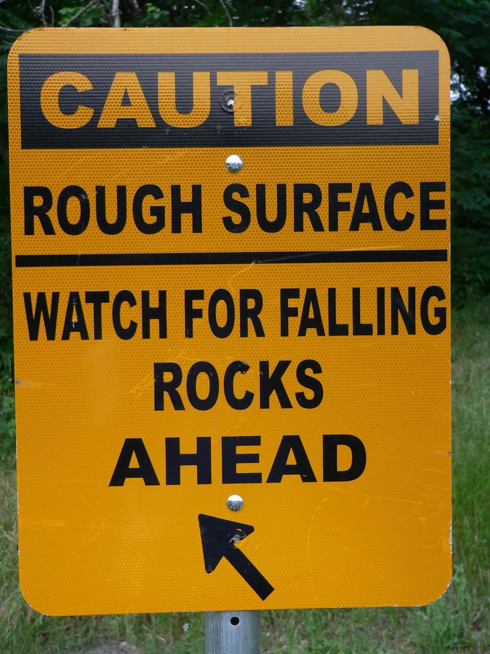 Sign warns of rough surface and falling rocks; Shoal Creek Trail, Austin, Texas