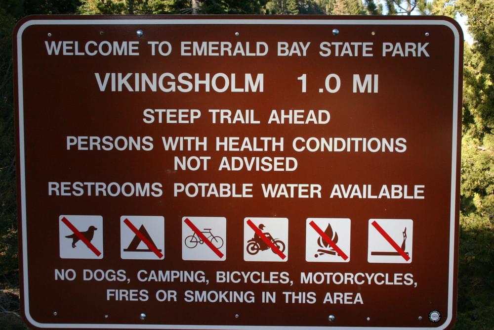 Sign describes conditions, distance, and uses allowed as well as warning; Emerald Bay State Park, California