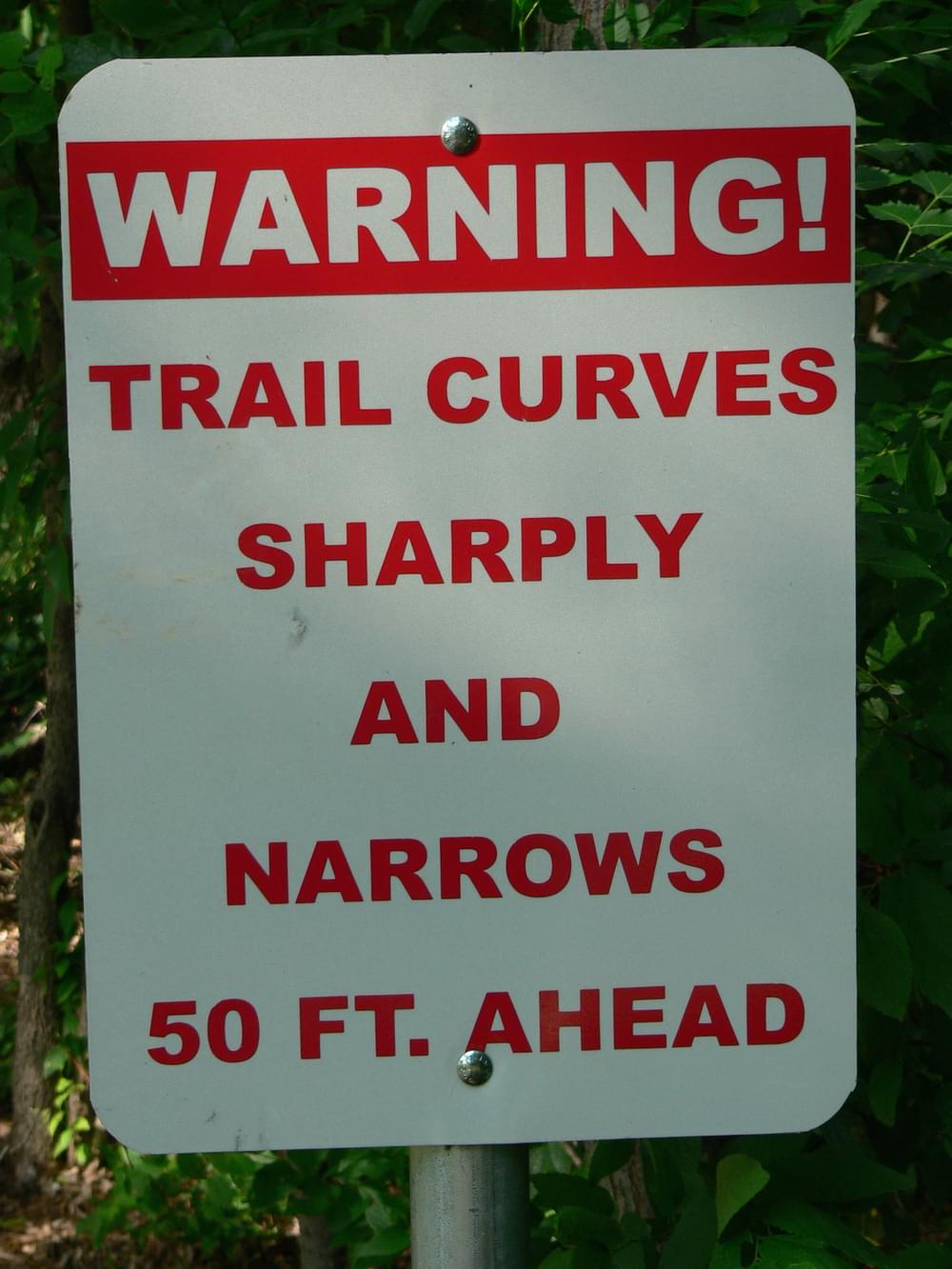 Sign where trail winds and crosses Shoal Creek; Austin, Texas