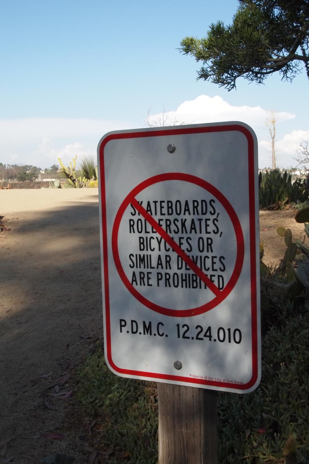 A dirt trail in San Diego's Balboa Park warns no wheels allowed